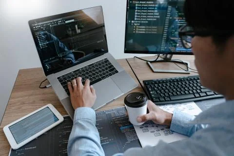 Programmer working On Computer In IT Office Typing Data Coding in software an 写真素材