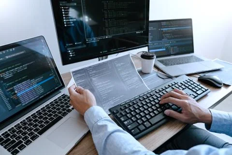 Programmer working On Computer In IT Office Typing Data Coding in software an Stockfoto's