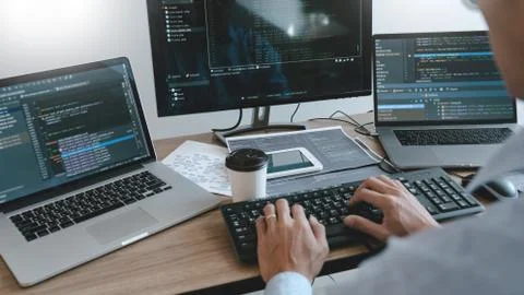 Programmer working On Computer In IT Office Typing Data Coding in software an Stock Photos