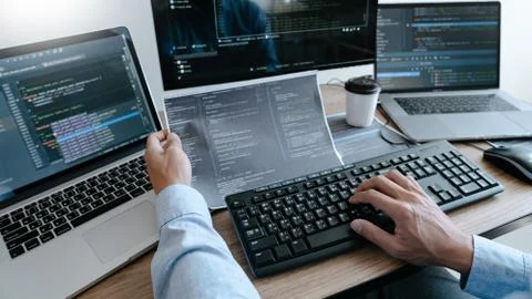 Programmer working On Computer In IT Office Typing Data Coding in software an Stockfoto's