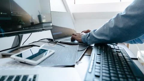 Programmer working On Computer In IT Office Typing Data Coding in software an Stock Photos