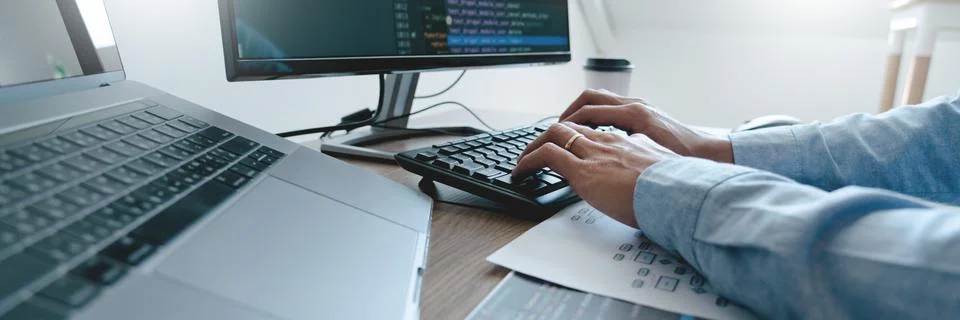 Programmer working On Computer In IT Office Typing Data Coding in software an Stock Photos