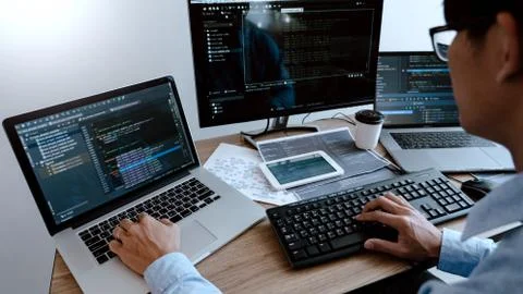 Programmer working On Computer In IT Office Typing Data Coding in software an Foto stock