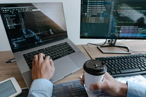 Programmer working On Computer In IT Office Typing Data Coding in software an Foto stock