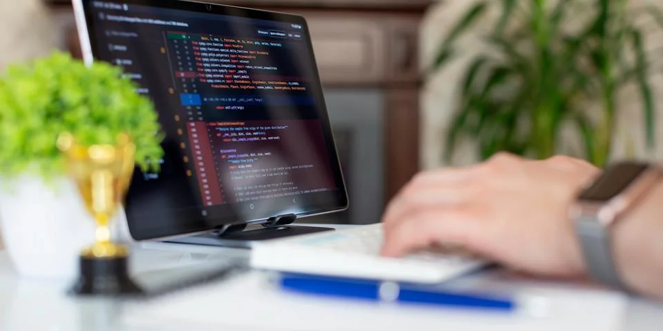 Programmer working with a computer in the office. Close-up of a man's hands.. Stock Photos