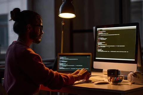 Programmer working on computer till late night Stock Photos