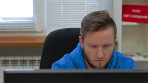 Programmer is working concerned on computer screen Stock Footage 73898334