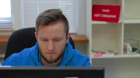 Programmer is working concerned on computer screen Stock Footage 73898503