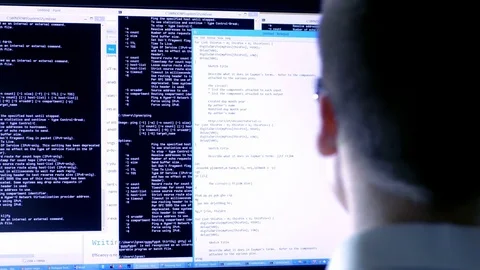 Programmer working with data and codes in front of a large computer screen. Stock Footage