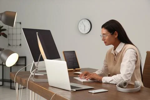 Programmer working at desk in modern office Stock Photos