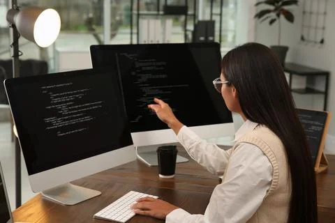 Programmer working at desk in modern office Stock Photos