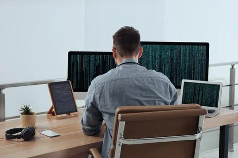 Programmer working at desk in modern office 写真素材