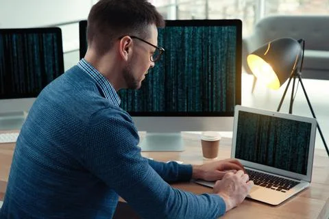 Programmer working at desk in modern office 스톡 사진