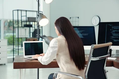 Programmer working at desk in modern office Stock Photos