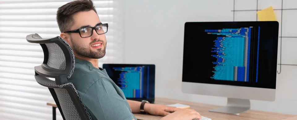Programmer working at desk in office. Banner design Stock Photos