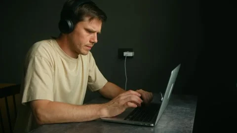 Programmer working from home on laptop and wearing headphones Stock-Footage 314893169