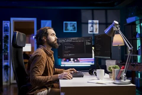 Programmer working from home securing company servers from DDoS attacks 写真素材