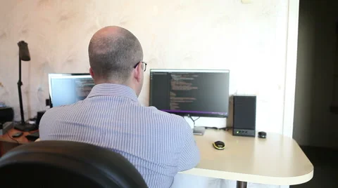 Programmer working at home sitting at the computer 스톡 동영상 64830580