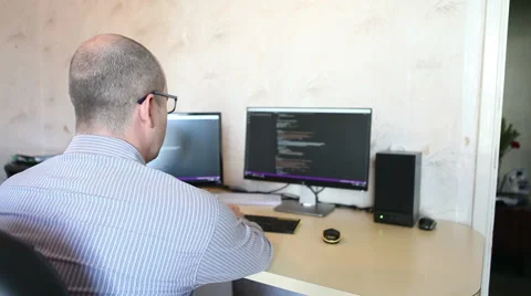 Programmer working at home sitting at the computer Stock Footage 64830588