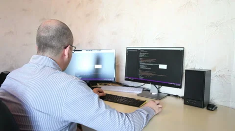Programmer working at home sitting at the computer 스톡 동영상 64830591