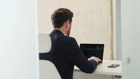Programmer working in an isolated room, typing on laptop, writing code. Stock Footage 238509485