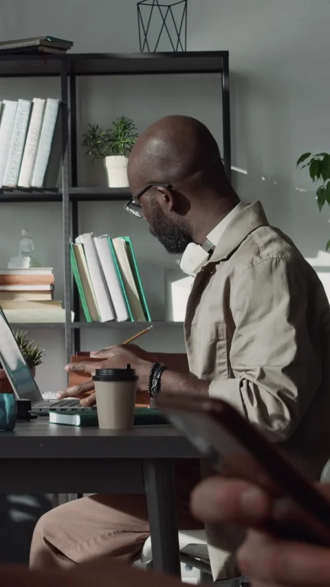 Programmer Working on Laptop and Taking Notes with Pencil during Workday Stock Footage 299199584