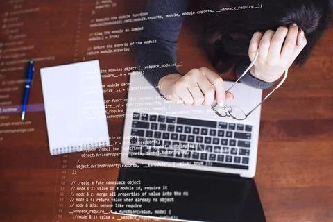 Programmer working on laptop computer and coding code on screen. Internet and Stock Photos