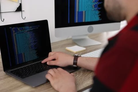 Programmer working with laptop at desk in office, closeup 스톡 사진