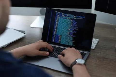 Programmer working with laptop at desk in office, closeup 스톡 사진