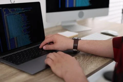 Programmer working with laptop at desk in office, closeup 스톡 사진
