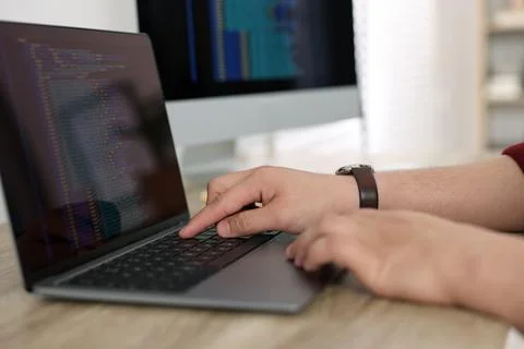 Programmer working with laptop at desk in office, closeup Foto stock