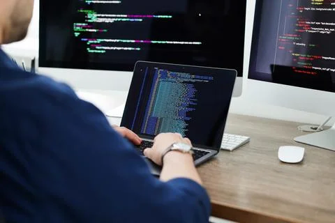 Programmer working with laptop at desk in office, closeup 写真素材