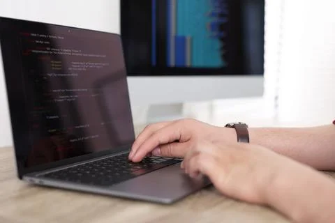 Programmer working with laptop at desk in office, closeup 스톡 사진