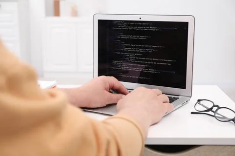 Programmer working with laptop at desk in office, closeup 스톡 사진