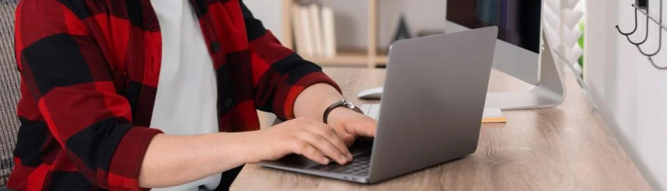 Programmer working with laptop in office, closeup. Banner design Stock Photos