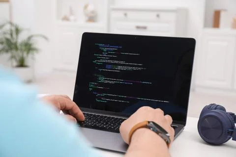 Programmer working with laptop at white desk in office, closeup 스톡 사진