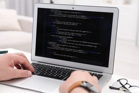 Programmer working with laptop at white desk in office, closeup 스톡 사진