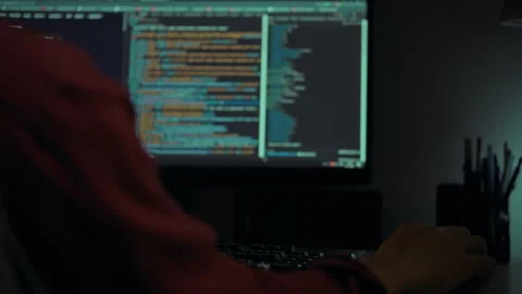 Programmer working late at night focused on computer code and creative tasks Stock Footage 295160588
