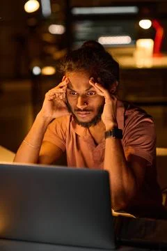 Programmer working over computer program in dark office Foto stock