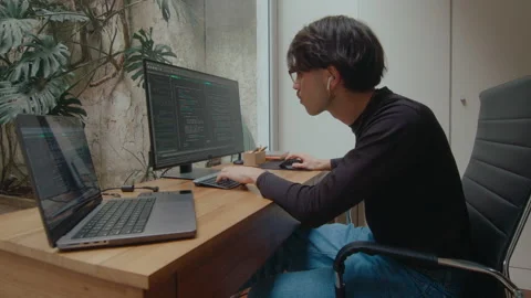 Programmer Working on PC and Laptop and Typing Computer Code Stock Footage 252753169