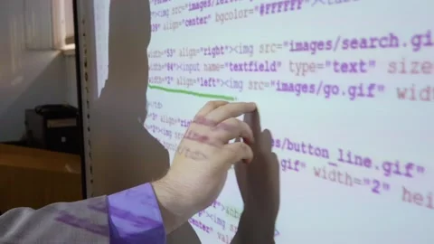Programmer working with program code on an interactive whiteboard close-up Stock Footage 145179881