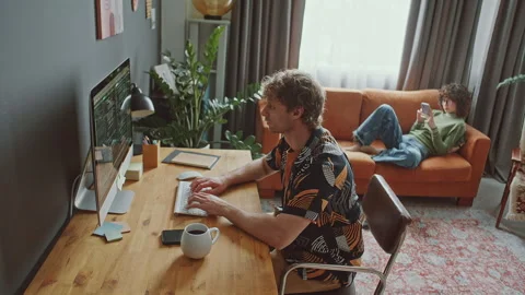 Programmer Working Remotely on Desktop Computer at Home Stock Footage 306459976
