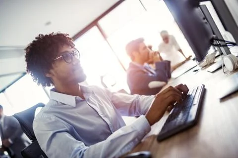 Programmer working in a software developing company office Stock Photos
