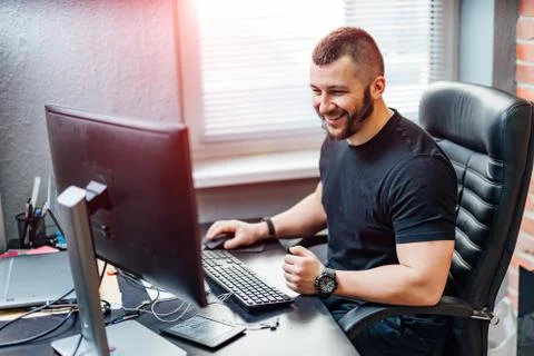 Programmer working in a software development company office Stock Photos