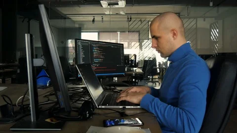 The programmer works at a computer in an empty office during quarantine. Working Video stock 127197358