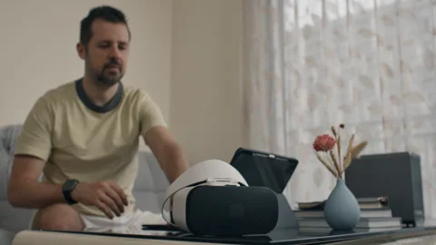 Programmer works on laptop coding VR headset and then tests the program Stock Footage 310329007