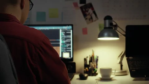 A programmer works on a laptop writes code for a new program that is connect Stock Footage 283681598