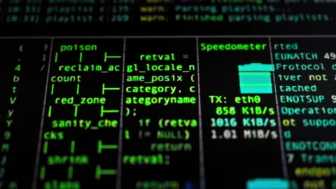 As programmer works on software development the monitor screen displays rapi Stock Footage 334546171