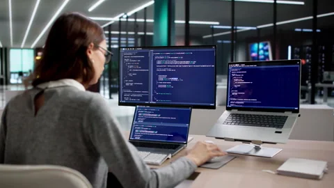 Programmer Writes Code On A Desktop Stockbeeldmateriaal 335454744