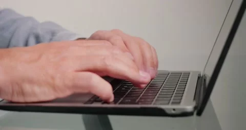 Programmer writes code for website using laptop in office Stock Footage 201039984